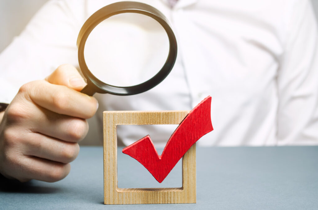 check mark through a magnifying glass