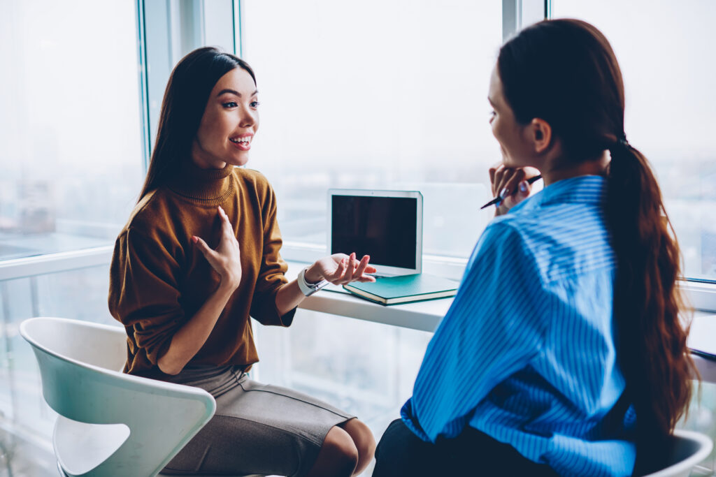 One-on-one emotional intelligence training of two women employees in the office.