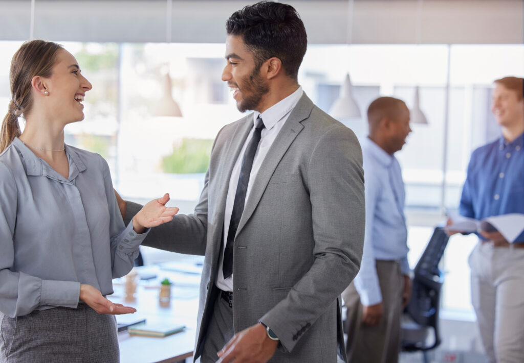 Sales representatives engaging in conversation at work