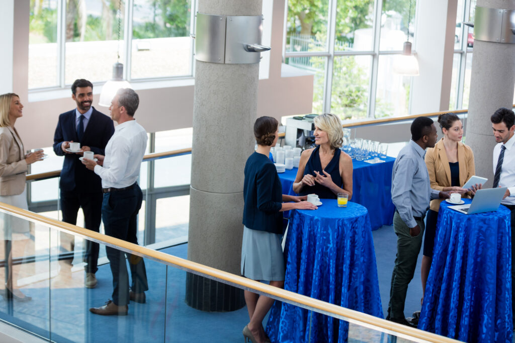 Business attendees engaging in conversations and connections during professional in-person events.