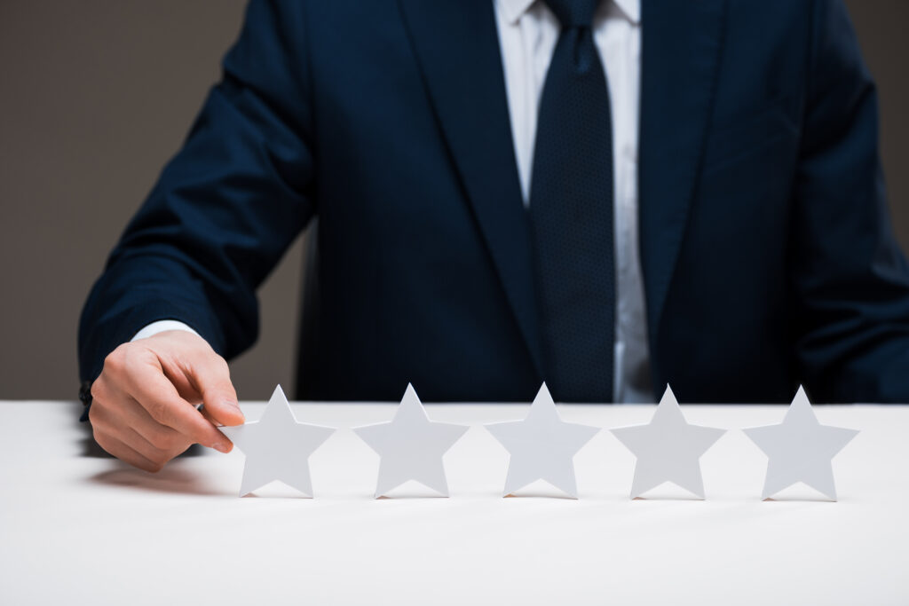 A professional arranging five-star ratings to represent Newbern Excel reviews and customer satisfaction.